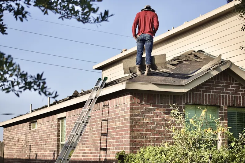 Professional roofer working on a residential roof in Linganore